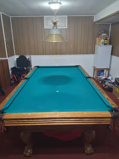 Elevate your game room with this classic, high-quality wooden pool table featuring a beautiful green...