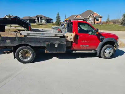 2009 f550 flatbed pickup truck. Slip tank, tool boxs, bunk heater For more information 780-938-6044...
