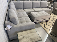 Grey fabric sectional with storage ottoman 