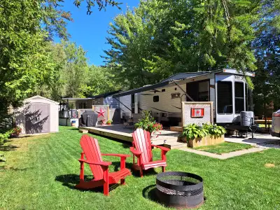 Destination trailer parked at Seasonal site in Kenorus-Revive Campground Port Elgin Ontario. One own...