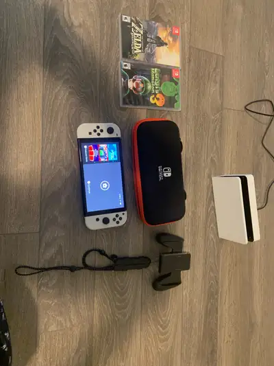 Nintendo switch OLED. 2 games and extra storage, View more