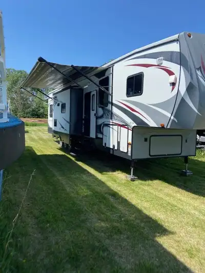 Heartland Road Warrior 4112 Toy Hauler Triple Slide Fifth Wheel with Garage / Patio & Residential Co...