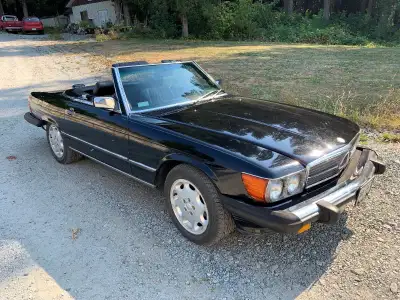 1989 Mercedes 560SL: Rare triple black. Hard and soft tops: Ice cold air conditioning. No rust ever....