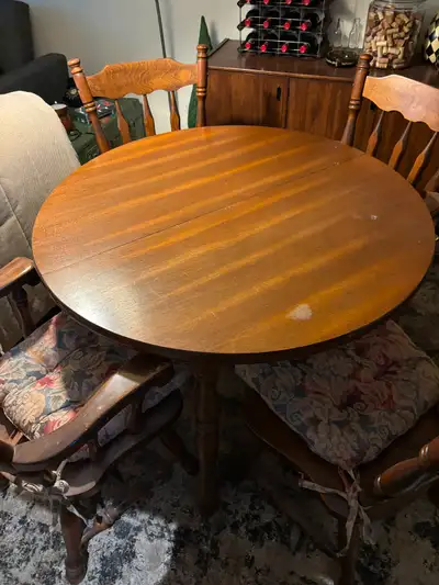 Solid wood table with 4 chairs. Deep brown colour with four legs – aprox. 29” tall by 41” wide. 2 in...