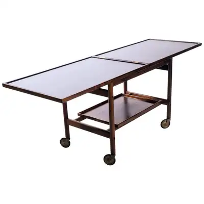 Beautiful Teque coffee table with adjustable top and serving tray. This coffee/bar table is on wheel...