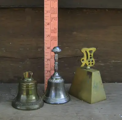 3 Vintage hand bells, see ruler for measurement. The short bell in front is dated 1953 $20 each
