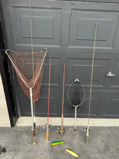 Assortment of antique fishing poles, nets and lures that would add to a collection or make great dec...