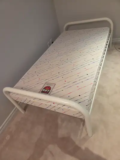 Like new metal bed frame (6 ft 8 inch) and used firm foam mattress (has a narrow 3 inch tear near a...