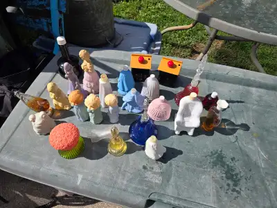 Vintage collection of Avon perfume and cologne bottles. This set includes various glass and plastic...
