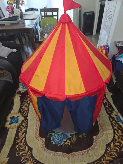 This kids' play tent is designed like a circus tent with red and yellow stripes. It includes poles f...