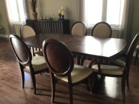 Solid hardwood dining room table with 10 chairs and extensions
