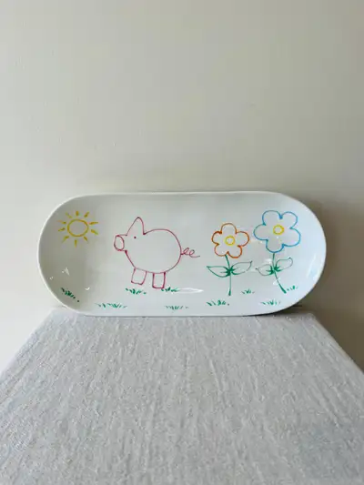 This is a beautiful large elongated serving platter. Surface has glazed finish all over other than t...