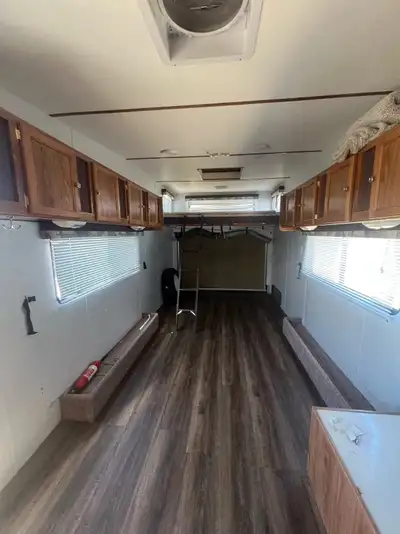 1999 Tahoe Toy Hauler Camper Kitchen; Large foam bed above loading ramp door; Solar Panels with char...