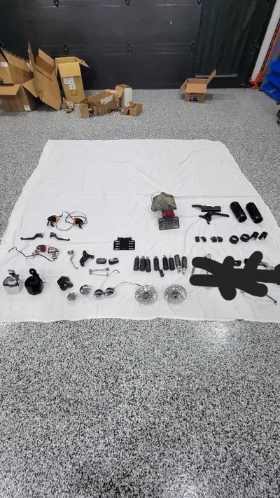 Miscellaneous parts Foot pegs Headlights Bullet lights Fork caps Exhaust brackets Tailight Fuel guag...