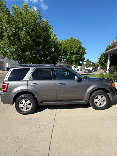 2011 Ford Escape XLT. Grey with black leather interior. Low km at 157000km. Good condition with some...