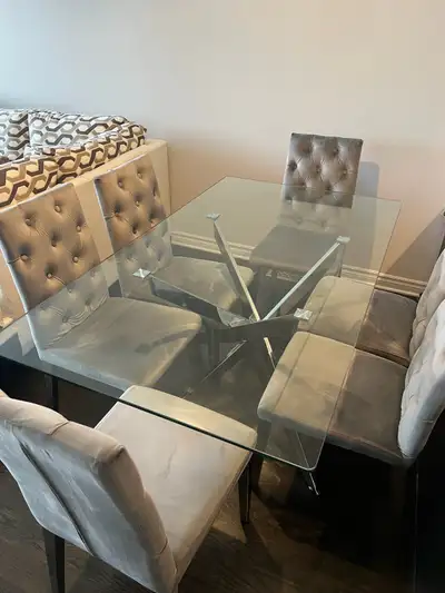 Like new modern glass dining table in chrome with 6 velvet chairs in excellent condition. Used for o...