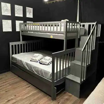 This sturdy grey trundle bunk bed offers a practical sleeping solution with a built-in trundle for e...