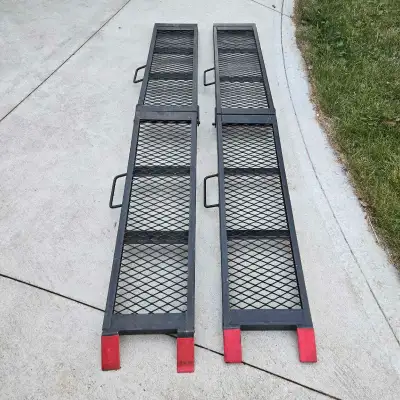 Available is a pair of used Erickson heavy duty steel mesh center folding loading ramps with carry h...
