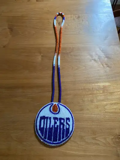 Oilers Hockey Pendent orange white blue beaded about 12 around and neck hanger about 18 inches