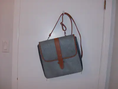 Grey felt and tan Messenger bag with cross-body strap. Zipper closing with pockets to keep you organ...