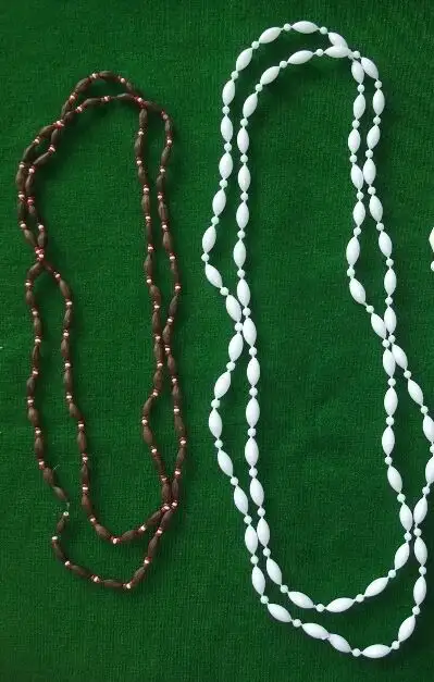 Two long, lightweight necklaces. One made of brown seeds with tiny red and white beads in between. 3...
