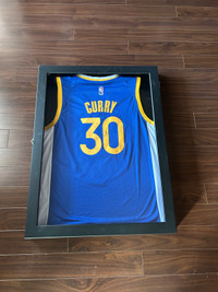 Steph Curry signed framed jersey. 