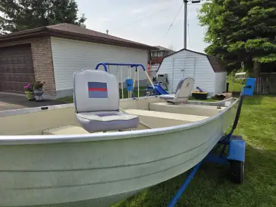 14 foot Mirrocraft boat with trailer, 2 swivel seats,2 oars, nights lights, includes a 9.9 Suzuki mo...