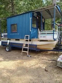 Custom made houseboat on oversized pontoons. Length is 20ft Comes with trailer Mercury 40hp two stro...