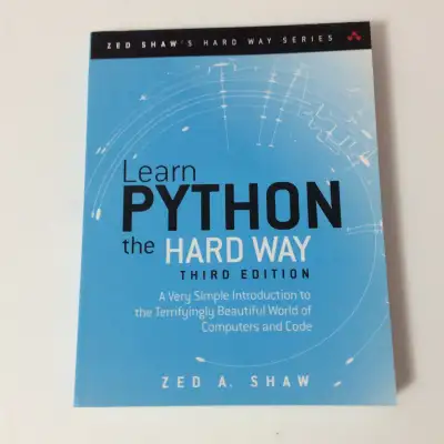 Learn Python the Hard Way, Third Edition by Zed A. Shaw. This book is part of the "Zed Shaw's Hard W...