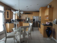 Maple Kitchen Cabinets, Island. Appliances, Oven, fridge, stove.