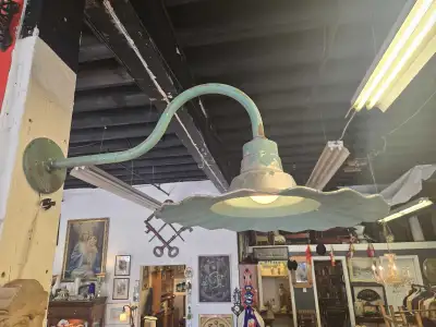 Illuminate your space with this charming vintage industrial light fixture! This used light features...