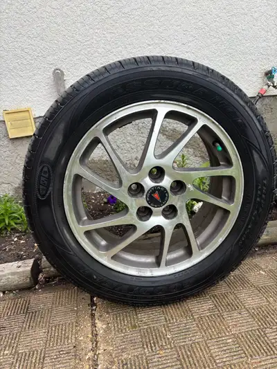 Set of 4 OEM rims for Grand Prix GTP c/w summer tires. Good condition.