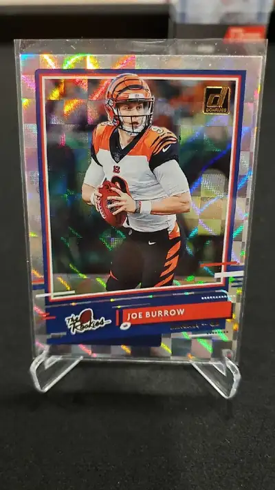 This is a Joe Burrow The Rookies card from 2020 Donruss. It is in mint condition. This card would be...