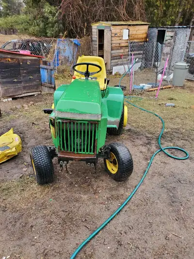 1987. 318 John Deere lawn tractor with cutting deck and push blade all hydraulically ran, has a 3 po...