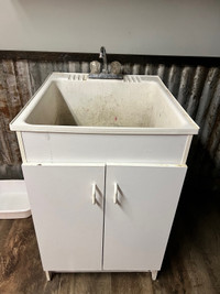 Used Laundry tub with cabinet 