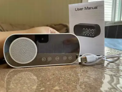 Clock bluetooth digital speaker with cable to charge.