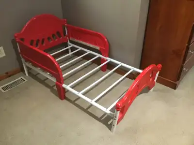 Plastic and metal toddler bed. Original colour pink repainted to red. Mattress in good condition as...