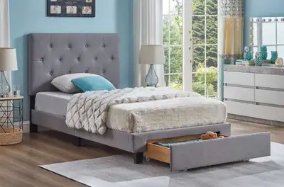 This is a stylish grey upholstered twin bed frame with button-tufted headboard and convenient under-...