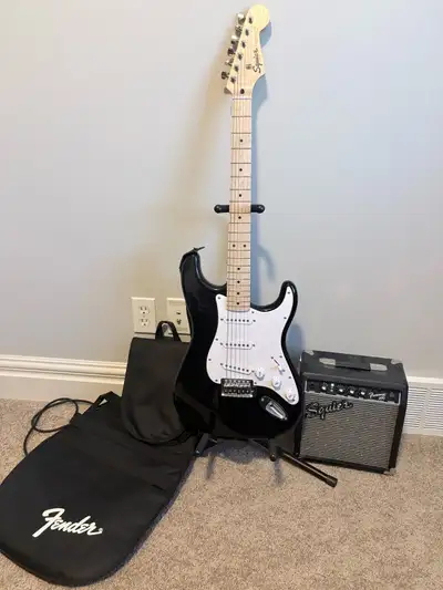Black Squier Stratocaster and Portable Amp. Comes with guitar bag and guitar stand. Guitar is very l...