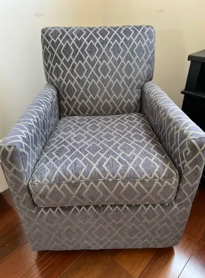 Grey swivel lounge chair for sale. Chair is grey with green diamond pattern. Chair is in good condit...