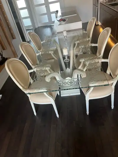 Table with wood base and engraved crystal glass top. 8 chairs with false leather . Dimensions 40Wx82...