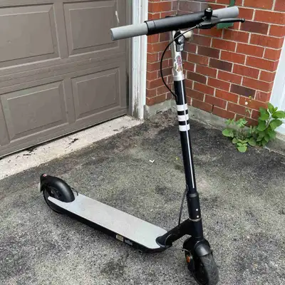 Adult size OKAI Neon ES20 scooter with charger, very visible for night time because it has lights un...