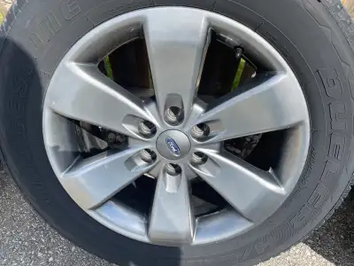 4 P275/55R20 Bridgestone tires on Ford F150 6bolt 20x8.5 rims 87.1 MM Bore.