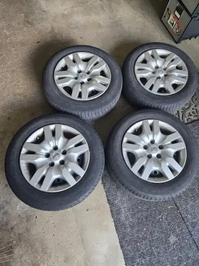 These Michelin 215/60R16 studless winter tires mounted on Nissan wheels from a Nissan Altima 2012. S...