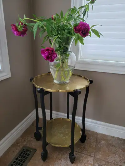 Vintage folding accent table with two engraved brass trays and carved black wooden frame. Beautiful...
