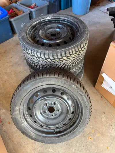 Set of four Norman North winter tires on black steel rims. Size: 225/45R17. Come from a Subaru Impre...