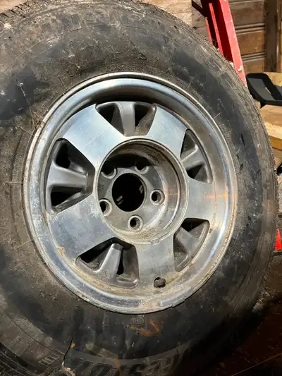 Set of 4, 15 inch rims with tires, three of the tires hold air, one does not. Rims are in decent sha...