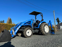 New Holland TC40 4X4 tractor with loader and backhoe.