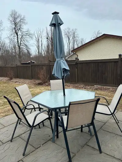 Glass outdoor table with umbrella and five chairs, View more