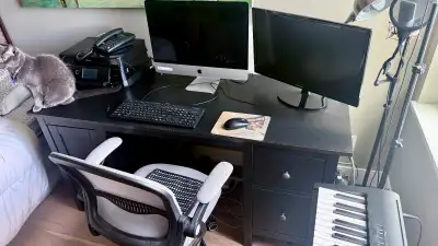 One espresso colored desk with three drawers in the right side and a door in the left It is 61.25 in...